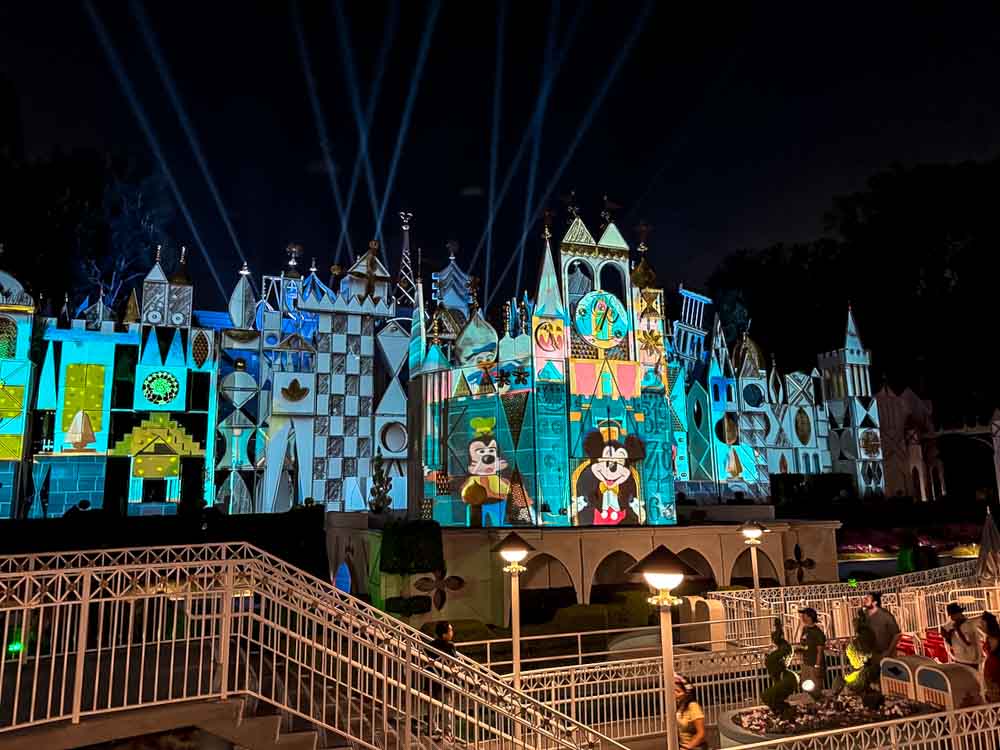 Mickey Mouse projection lighting up it’s a small world exterior at night during our 3-Day Disneyland California Itinerary.