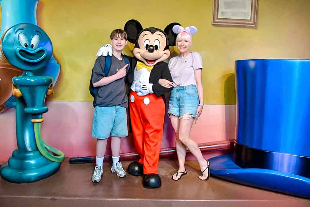 Family photo with Mickey Mouse inside his Toontown house at Disneyland California, a highlight of our 3-Day Disneyland California Itinerary.