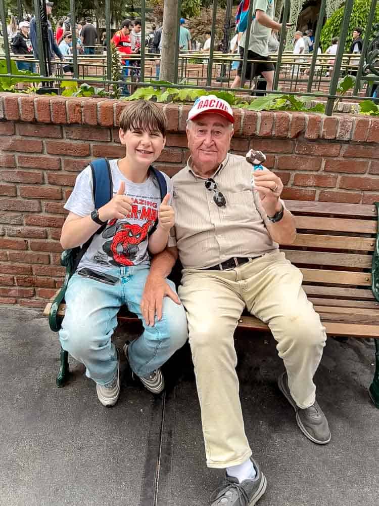 My dad and Jackson enjoying Mickey ice cream sandwiches at Disneyland, part of our 3-Day Disneyland California Itinerary.