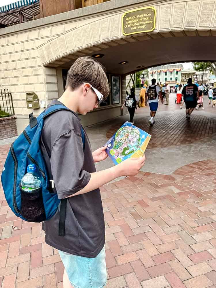 My son Jackson studying the Disneyland California park map at the start of our 3-Day Disneyland California Itinerary.