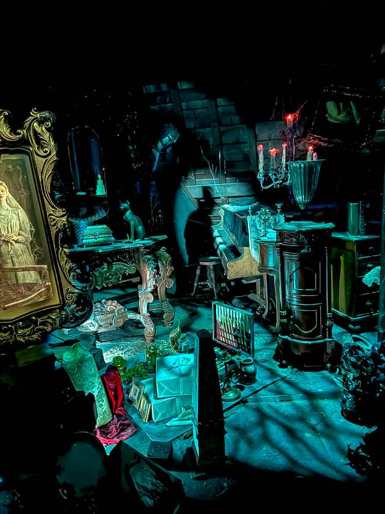 Haunted Mansion ride scene during a 3-Day Disneyland California Itinerary, showing spooky props and glowing ghostly effects inside the attraction.