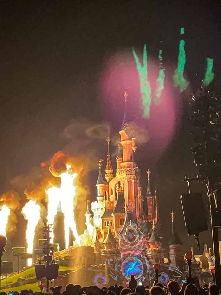 Sleeping Beauty Castle lit with pyrotechnics and fireworks at Disneyland Paris, where Disneyland Paris rules ensure safe viewing for crowds.
