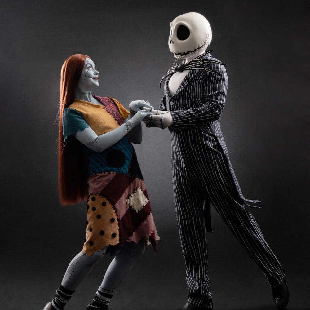 Jack Skellington and Sally holding hands in their Nightmare Before Christmas costumes at Halloween at Disneyland Paris 2025.