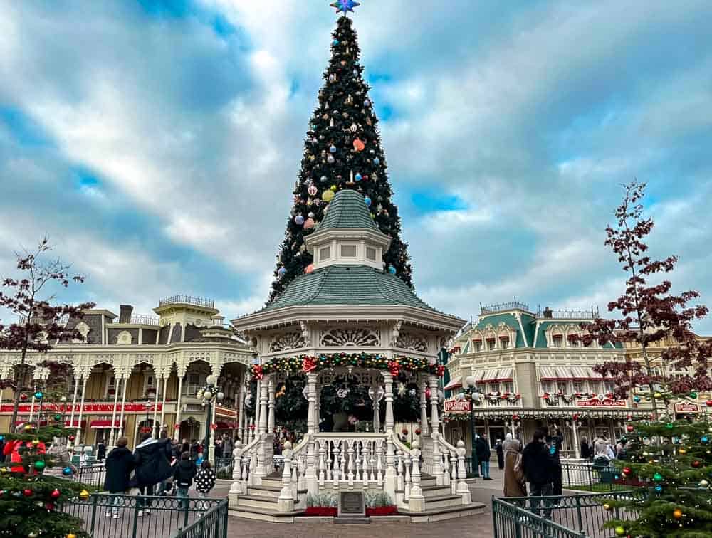 Town Square Christmas tree and gazebo at Disneyland Paris decorated with lights and garlands for the holiday season in December at Disneyland Paris