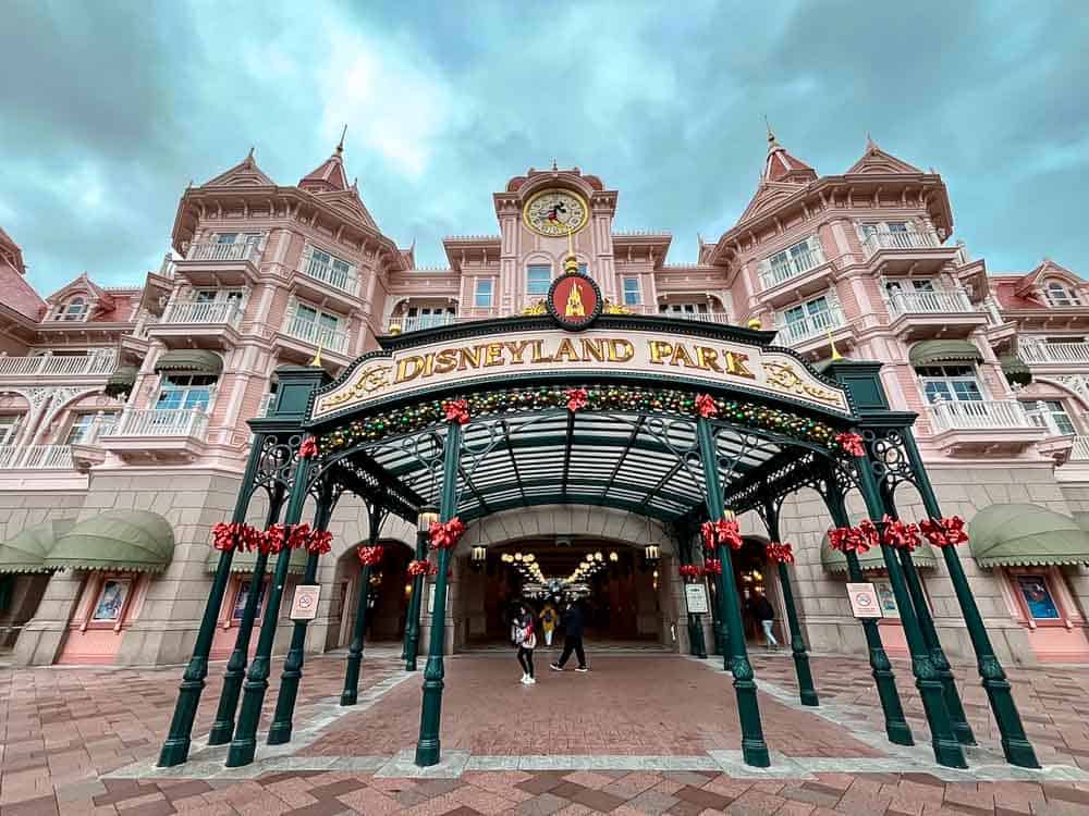 Disneyland Hotel entrance at Disneyland Paris decorated with Christmas garlands and lights during the December season.