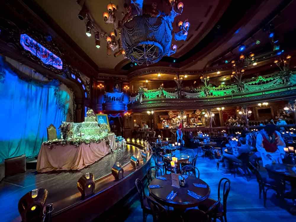 Stage display featuring a haunted wedding cake, candles and cobwebs inside the Unlucky Nugget Saloon at Disneyland Paris Halloween 2025.