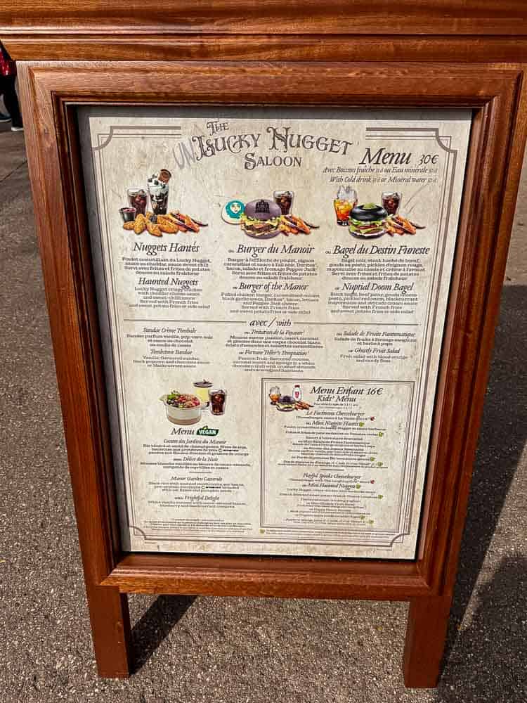 Menu board for the Unlucky Nugget Saloon showing Halloween 2025 table-service meals and drinks at Disneyland Paris.