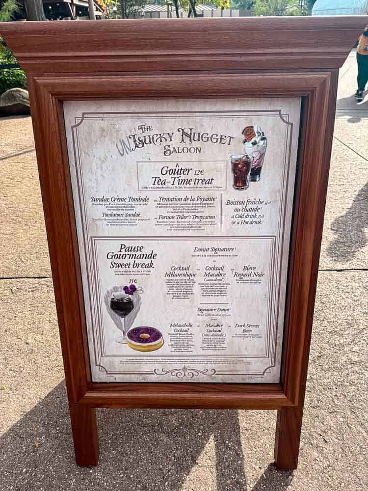 Menu board for the Unlucky Nugget Saloon’s €15 Sweet Break including the Mélancholique cocktail and signature donut at Disneyland Paris Halloween 2025.