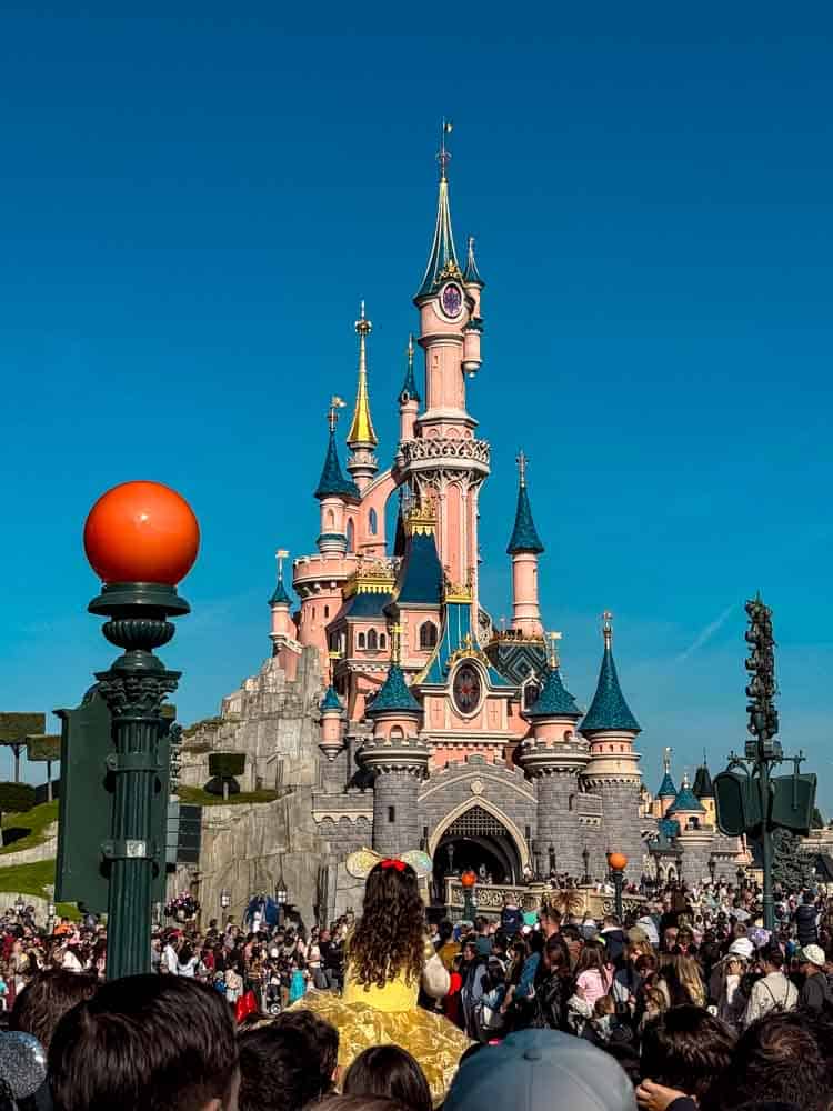 Sleeping Beauty Castle at Disneyland Paris with pumpkins and Halloween flowers in front