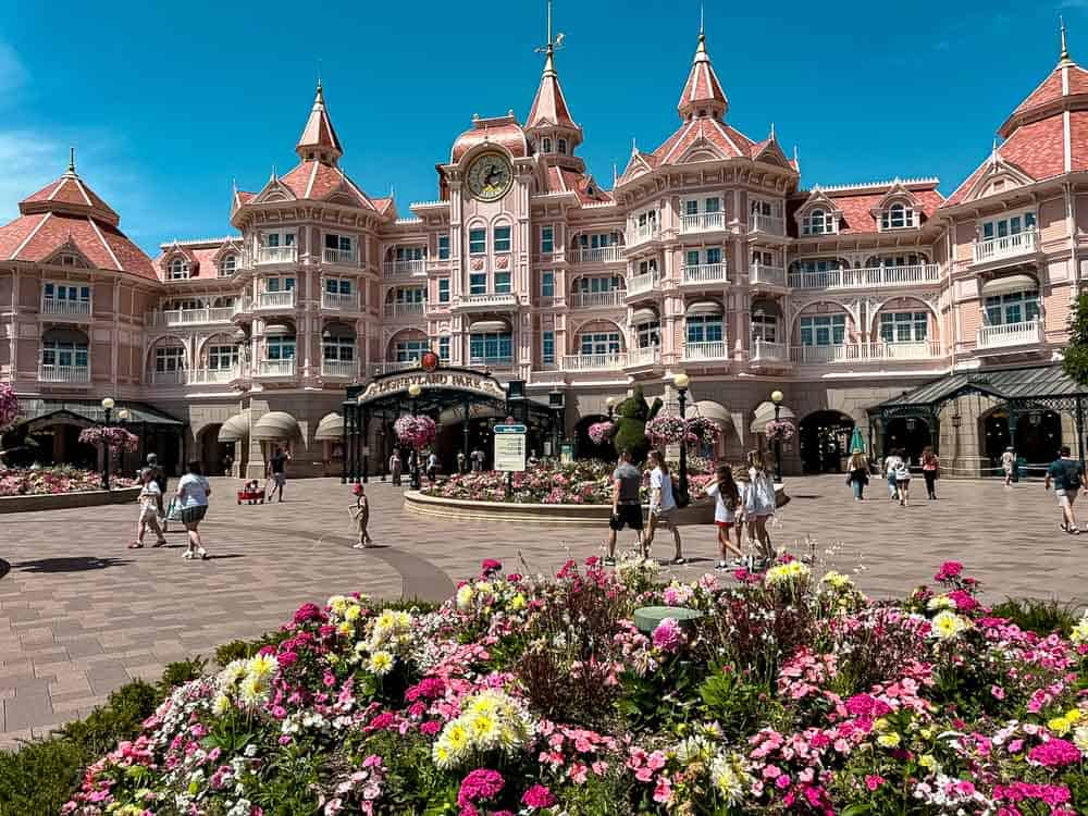 Disneyland Hotel entrance with flowers in front — planning a trip with the cheapest Disneyland Paris tickets.