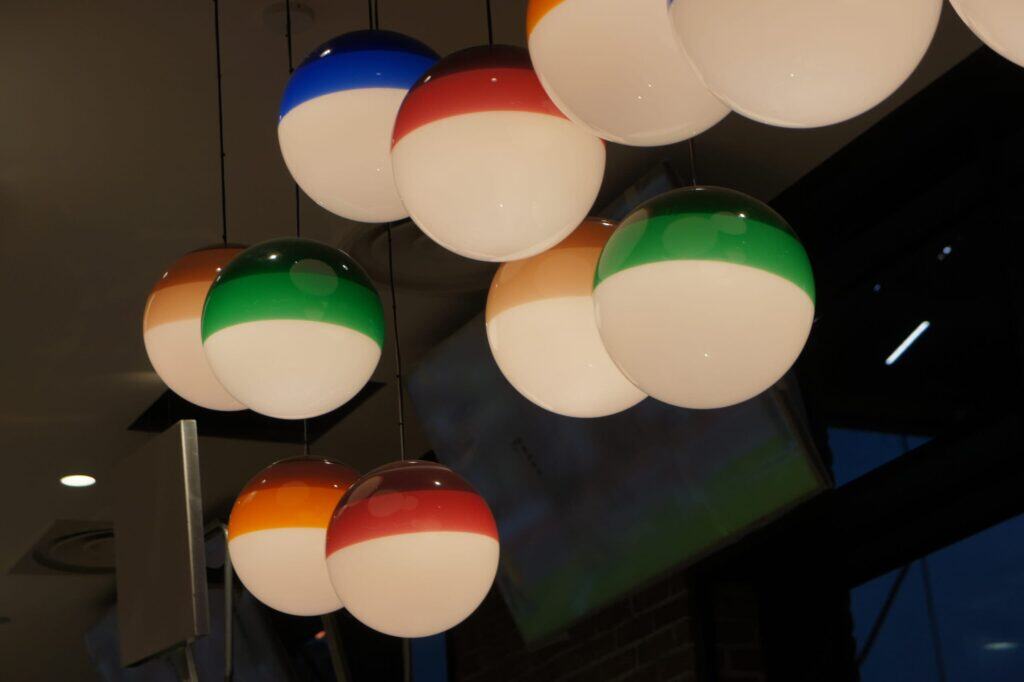 Colourful sports-themed ceiling lights inside the Sports Bar at Disneyland Paris.