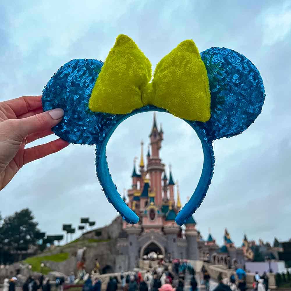 Minnie Mouse ears held up in front of Sleeping Beauty Castle at Disneyland Paris in January.