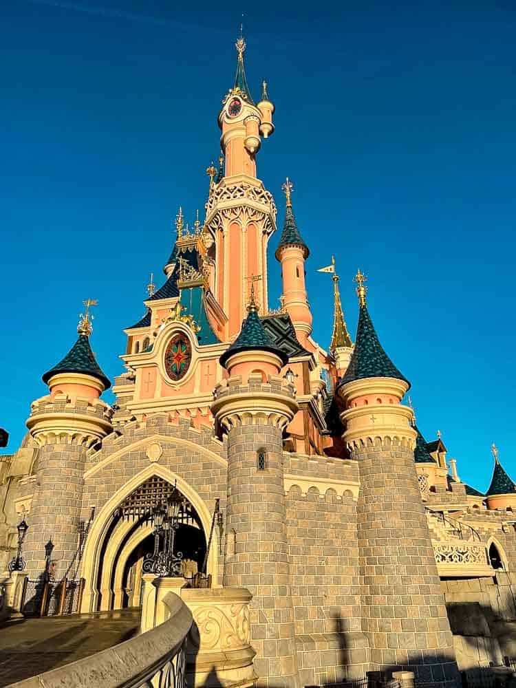 Iconic pink fairy tale castle with turrets and no crowds, perfect for first-time visitors in February at Disneyland Paris.