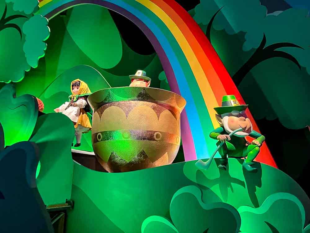St Patrick’s Day scene inside It’s a Small World during March at Disneyland Paris, with a rainbow and leprechaun characters