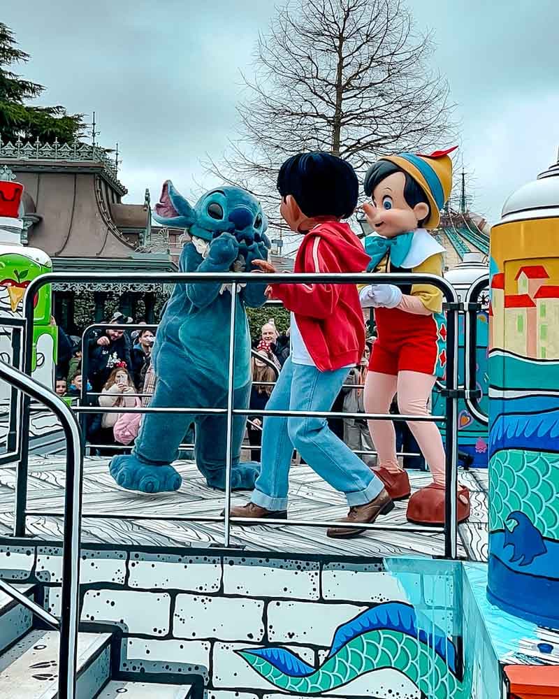 Stitch, Lilo and Pinocchio performing in the Million Splashes of Colour parade at Disneyland Paris.