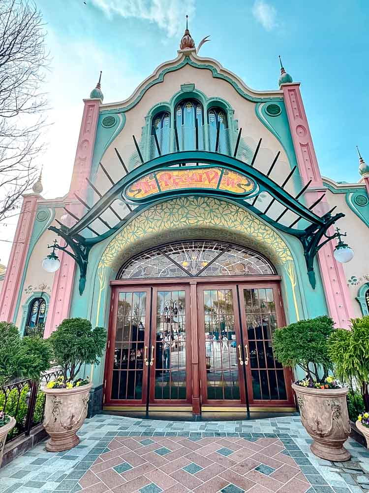 Regal View restaurant exterior in Disney Adventure World Disneyland Paris with pastel pink and green façade