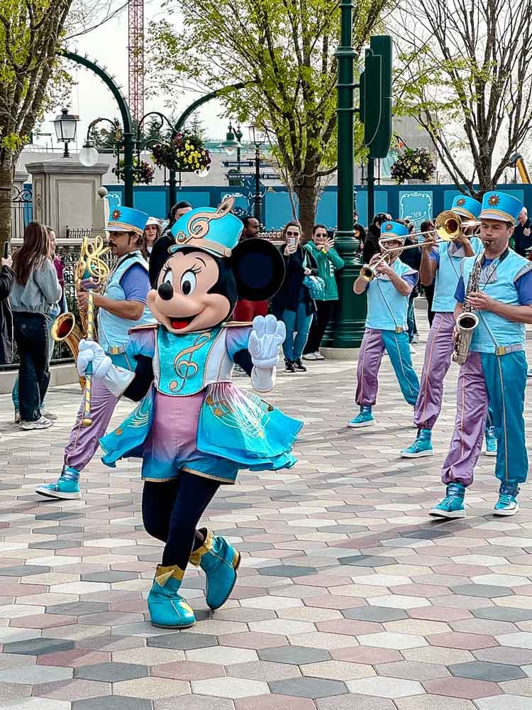 Minnie Mouse leading a marching band performance at Disney Adventure World Disneyland Paris entertainment