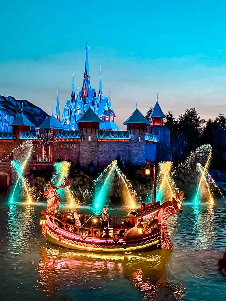 Boats lit up on the lagoon during Celebration in Arendelle show at Disney Adventure World Disneyland Paris