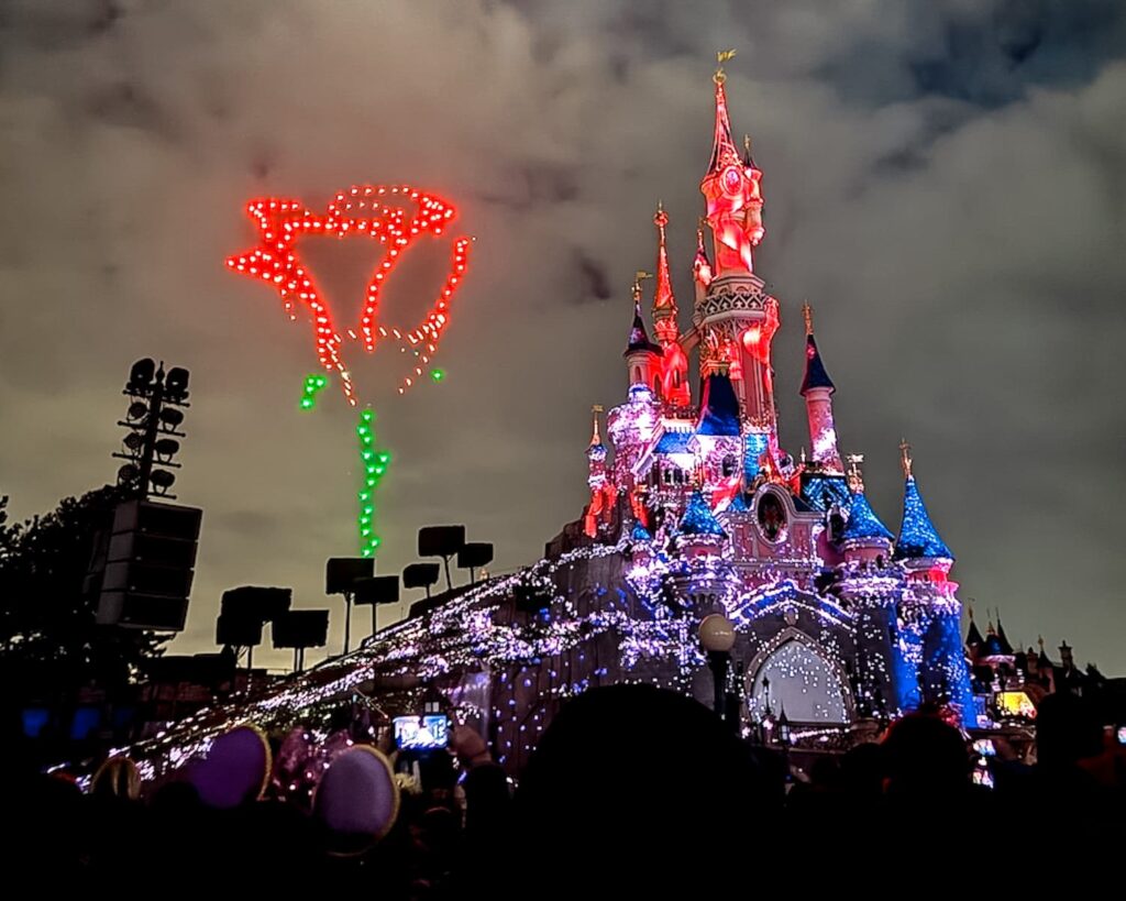 Tales of Magic drones forming a rose above Sleeping Beauty Castle during the Disneyland Paris nighttime show