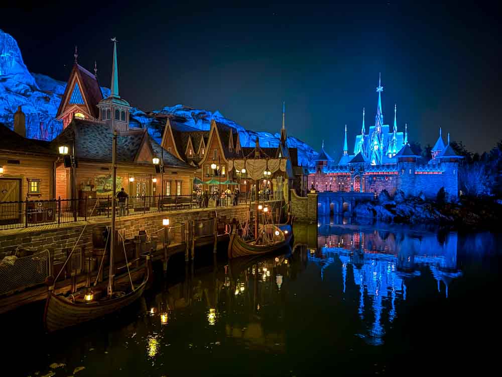 Nighttime view of World of Frozen and castle reflections at Disney Adventure World Disneyland Paris worth it evening atmosphere