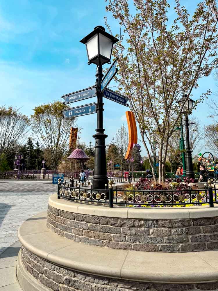 Signpost pointing to World of Frozen and Toy Story Playland in Disney Adventure World Disneyland Paris worth it navigation view