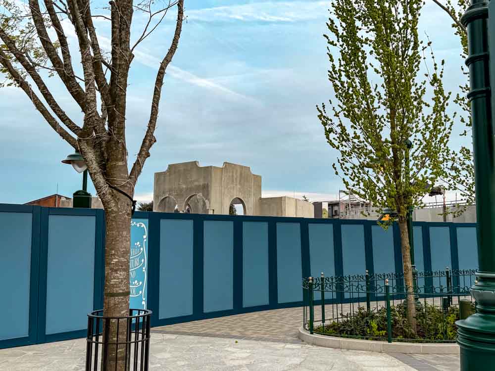 Construction walls and cranes at Disney Adventure World showing unfinished areas when deciding if it is worth visiting