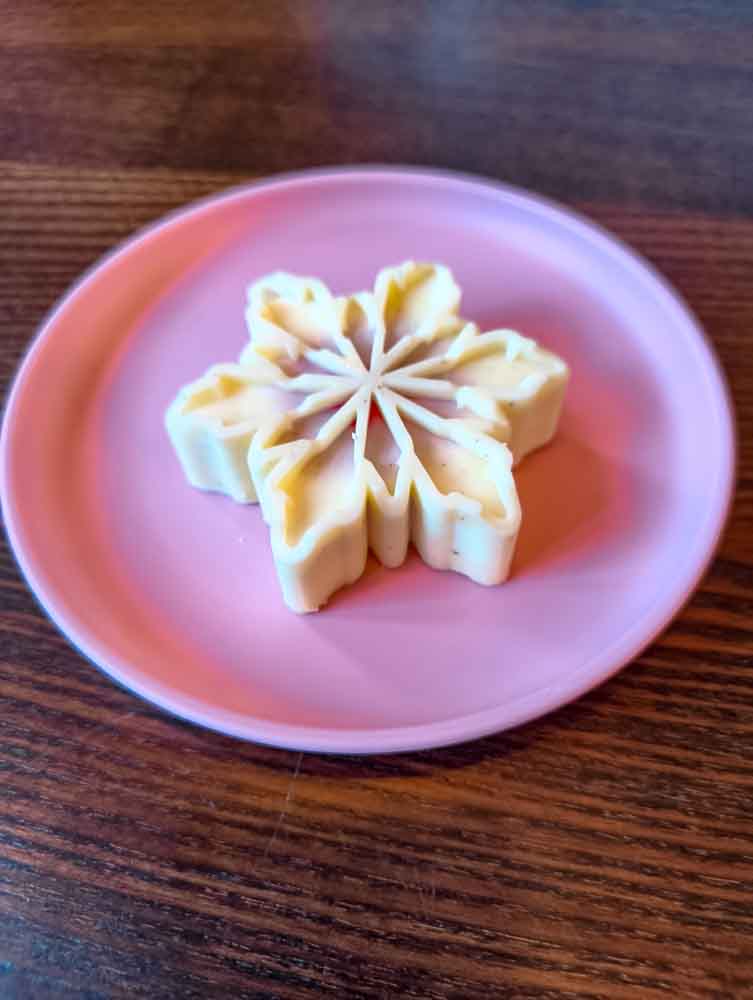 snowflake shaped shortbread cookie dessert on pink plate at Disneyland Paris food review 2026