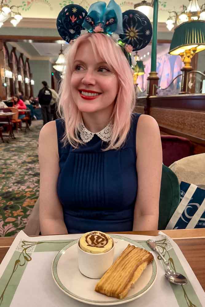 Carrie-Anne enjoying dessert at Regal View Restaurant Disneyland Paris during a princess dining experience