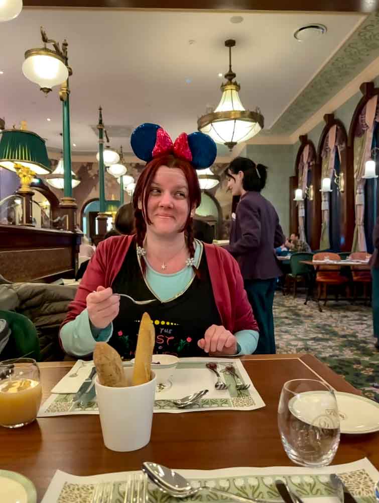 Guest trying the amuse bouche at Regal View Restaurant Disneyland Paris featuring soy-marinated grapefruit with Greek yogurt