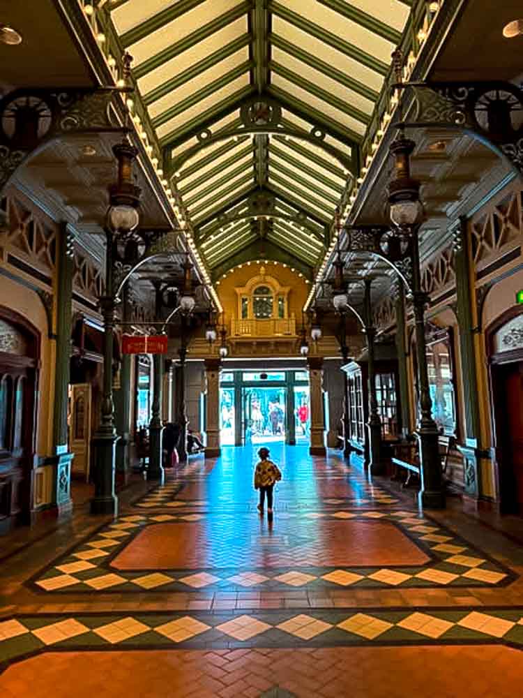 Disneyland Paris with a 3 year old — exploring the indoor arcade at the side of Main Street USA