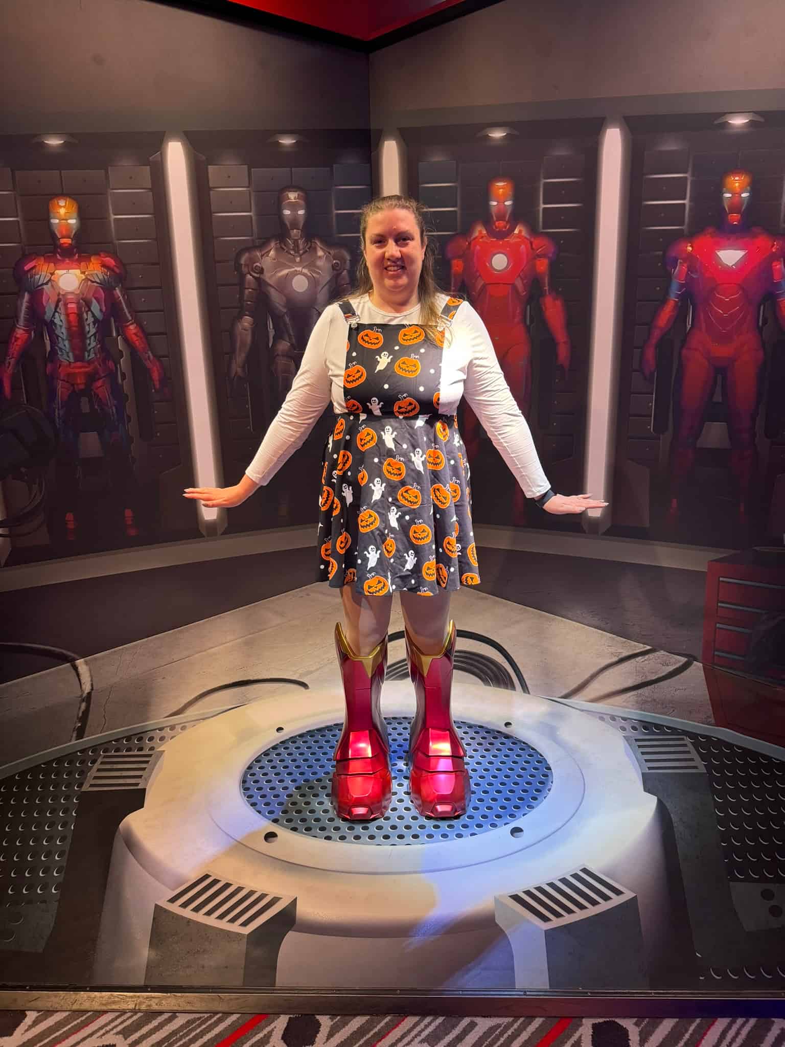 Guest posing with Iron Man suits at the Disney Hotel New York – The Art of Marvel Super Hero Station